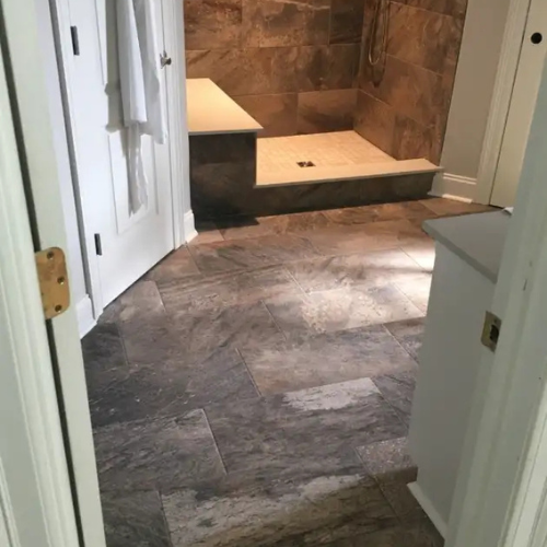 bathroom with a custom tiled walk-in shower